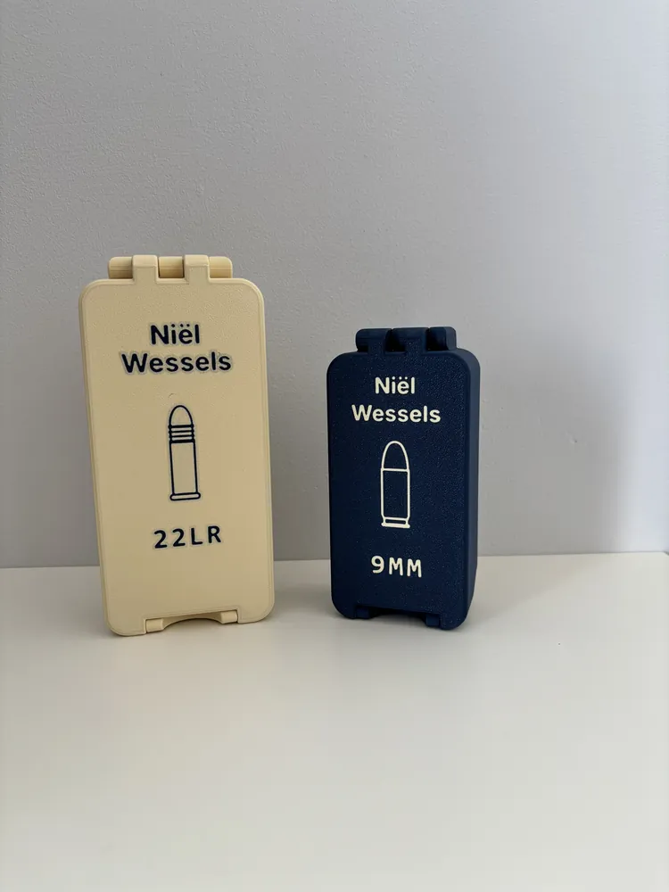 Cream and navy hinged boxes with a name, a cartridge icon and 22LR or 9MM labels