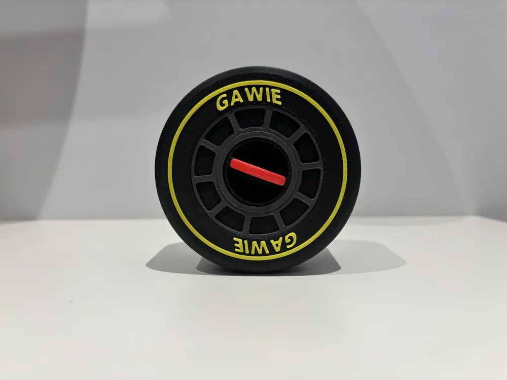 Black F1-style tyre with yellow stripe and a personalised name