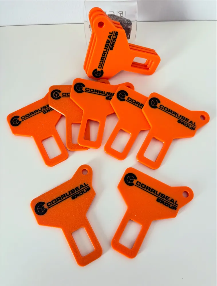 Orange seatbelt-buckle keyrings printed with a company logo